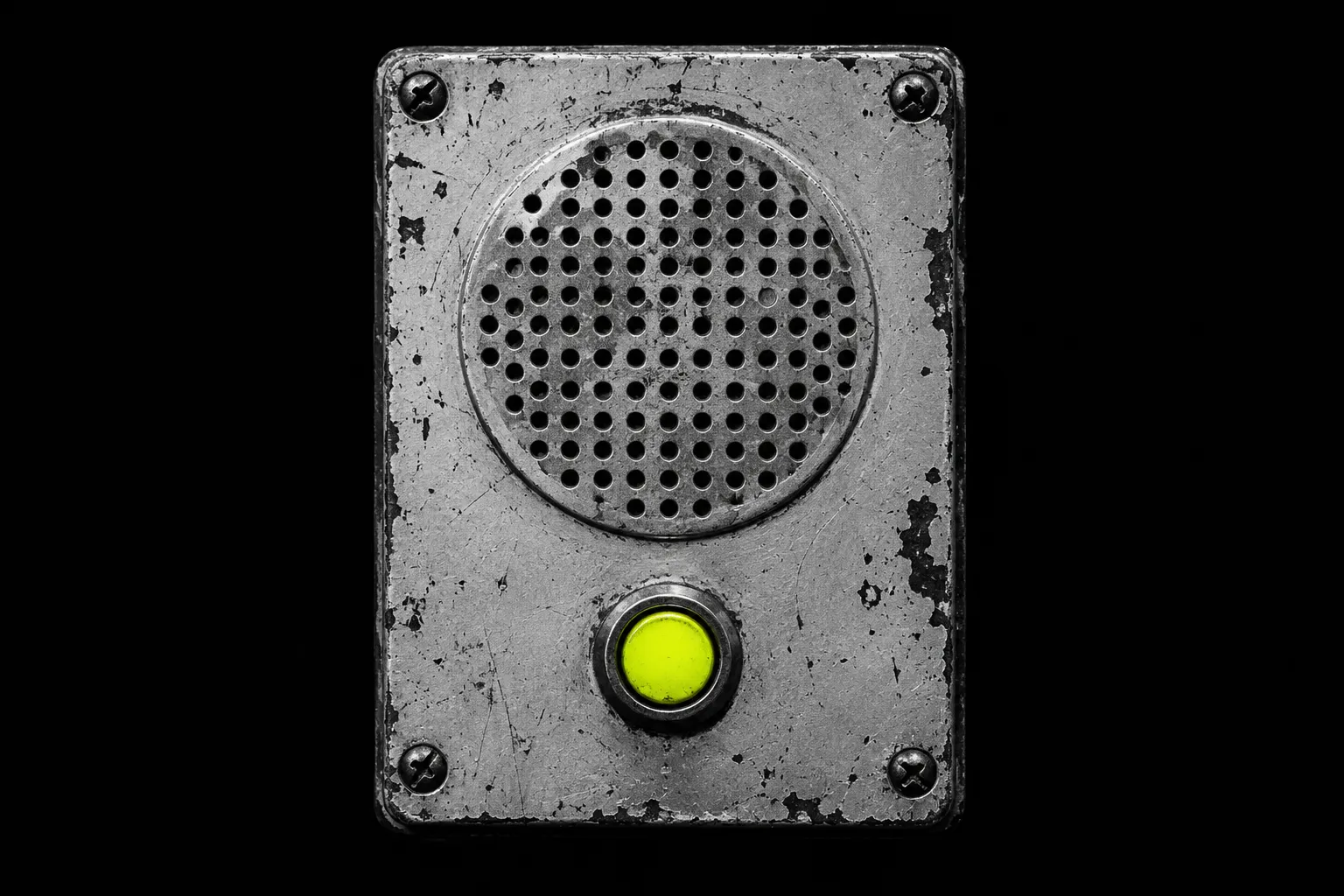 An old wall intercom speaker on black, its talk button lit yellow-green.